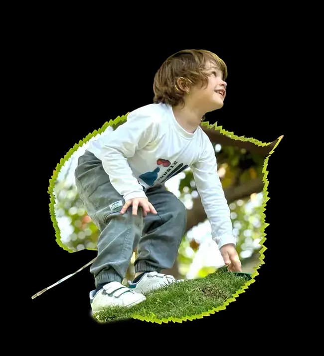 Child sitting in a leaf frame